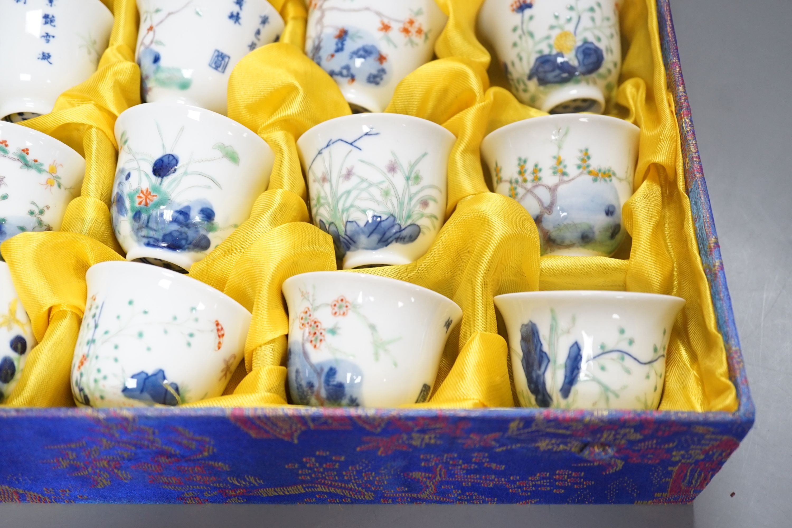 A Chinese boxed set of twelve wucai ‘month’ cups